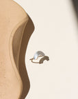 Curved hammered stacking ring in sterling silver with a rainbow-like arc shape
