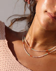 Model wearing full strand beaded necklace with moonstone, chrysoprase, and carnelian gemstones