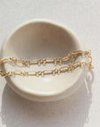 Callie Bracelet by token jewelry on a white ring dish