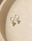 Sterling Silver hoops with chalcedony and ethiopian opal beads on a light dish