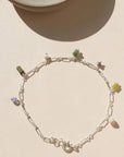 sterling silver anklet with gemstone bead charms on a light background