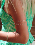 model wearing 14k gold fill wavy arm cuff