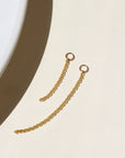 14k gold fill connector earrings, with a small rolo chain dropped from two 4mm jump rings, displayed on a cream backdrop in the sunlight