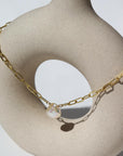 Eden anklet in 14k gold fill on a tan pot