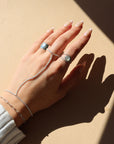 Model wearing sterling silver hand chain in the sunlight