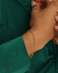model wearing 14k gold fill bracelets
