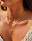 Laguna Pendant Necklace with faceted teardrop blue-green fluorite on petite gold fill box chain, styled layered with other sparkly chains