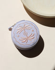 lavender circle travel jewelry case on a light background