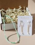 Token Jewelry's mini mystery box featuring a necklace and pair of earrings