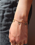 Model wearing 14k gold fill Birth flower charm bracelet. This Bracelet feature the Demi Alexandra chain with as many birth flower charms as you want.