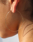 Model wearing 14k gold fill Silhouette Hoops