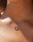 Model wearing 14k gold fill spiral Necklace. This necklace features the simple chain with the spiral eternity disc.