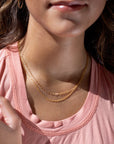 Model found wearing 14k gold fill Gemma Chain paired with the narrow link chain.
