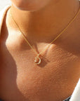 Model wearing Moon Star Charm Necklace in 14k gold fill