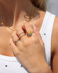 Model wearing Mojave Turquoise Ring with a blend of turquoise, spiny oyster shell, and copper set on a textured hand-hammered band.