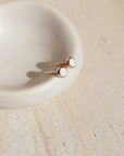 14k gold fill Opal Studs laid on a white plate in the sunlight. - Token Jewelry