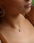 Minimal bezel-set labradorite pendant necklace on gold chain, handmade by Token Jewelry
