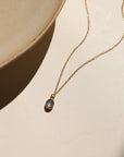 Minimal bezel-set labradorite pendant necklace on gold chain, handmade by Token Jewelry