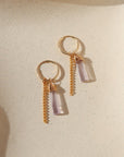 14k gold fill hoop earrings with pink amethsyt charms and sterling silver chain on a light background