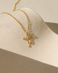 Delicate gold ribbon necklace with a minimalist bow design