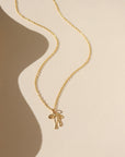 Delicate gold ribbon necklace with a minimalist bow design