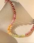 multi colored stone beads with pearls necklace displayed in the sunlight