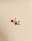 14k gold fill bezel earring setting with ruby stone in the sunlight