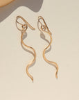 14k gold fill swivel earrings on french ear hooks on a light background