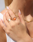 Model wearing Sienna Ring featuring a vibrant spiny oyster gemstone on a hand-hammered gold filled band.