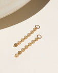 14k gold fill connectors featuring a short circle chain, dropped from a 4mm jump ring, displayed on a cream back drop in the sunlight
