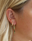 model wearing 14k gold fill stud earrings with chain and tourmaline beads