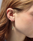 Model wearing 14k gold fill threaders with two coral beads, two turquoise tubes, and one serpentine bead jumped to the bottom of each threaders