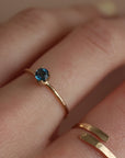 A timeless soft London blue topaz sits on a 14k gold solitaire band, December birthstone, soft blue hue, gift, handmade in eau claire, wisconsin, handmade jewelry, heirloom collection, everyday solid gold, solitaire ring, blue gemstone ring