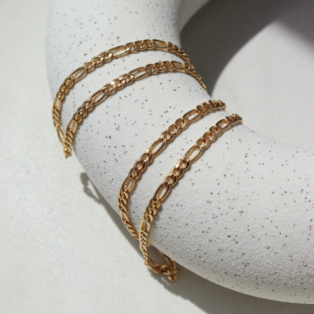 14k Gold Fill Gigi Necklace laid on a white plate in the sunlight.