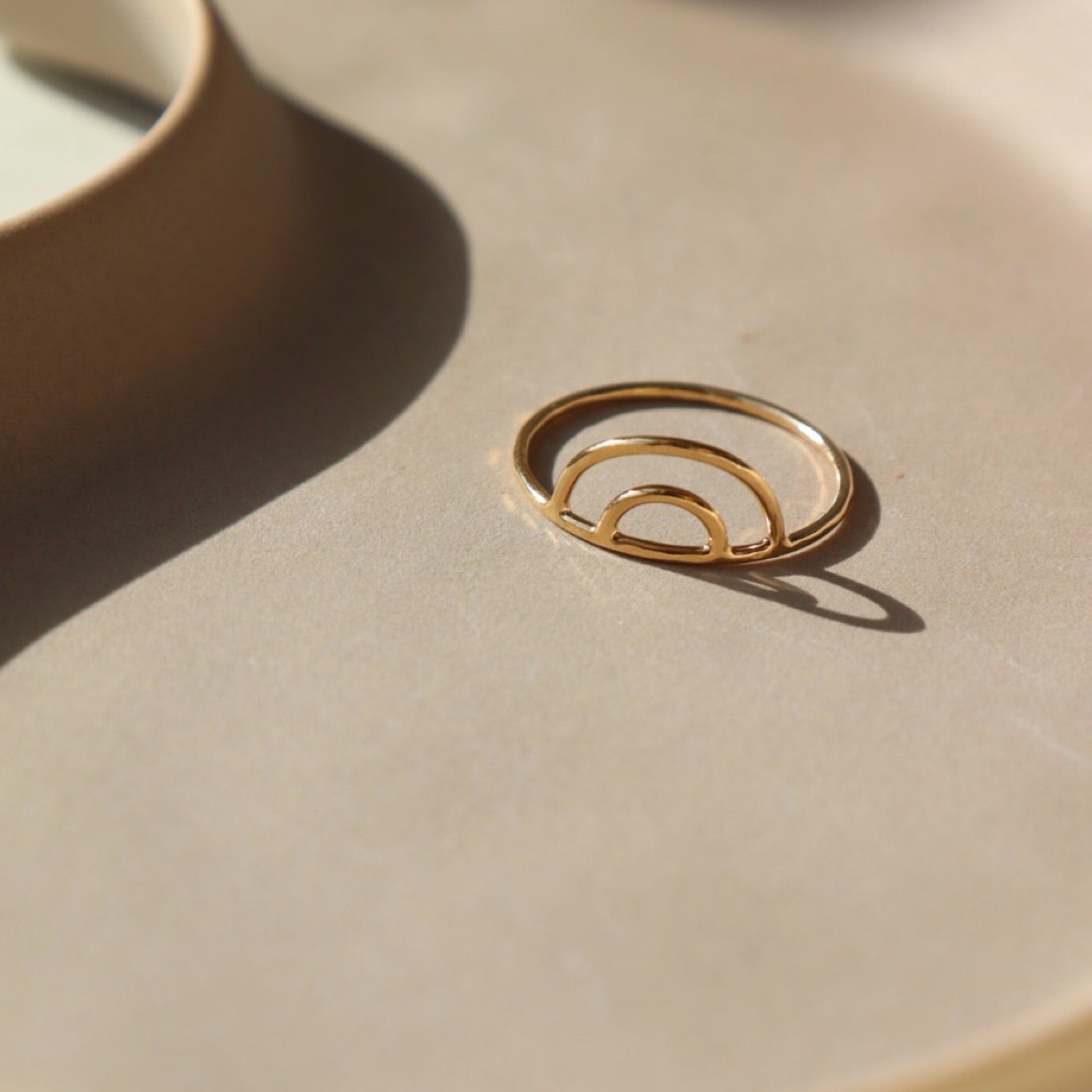14k gold fill rainbow ring on a tan plate
