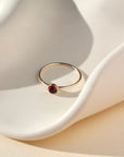 14k gold fill thin ring band with a 4mm red garnet stone