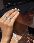 a 14k gold fill hand-set ocean jasper ring photographed on a model wearing silver jewelry and a black cowboy hat