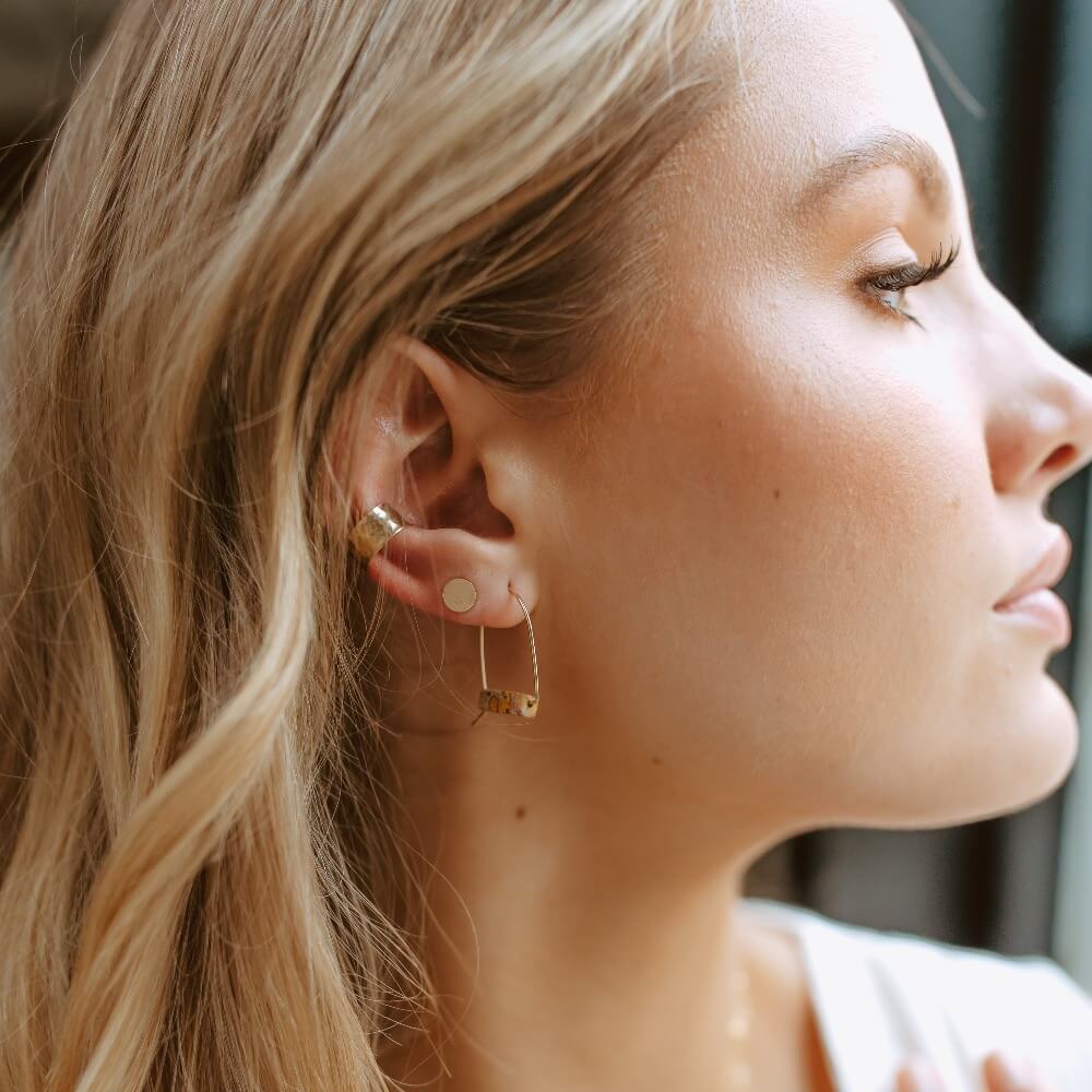 Hammered 14k gold filled ear cuff shown with 14 gold filled circle Studs and Leopard Skin Jasper Hoops on model - Handmade by Token Jewelry in Eau Claire, WI