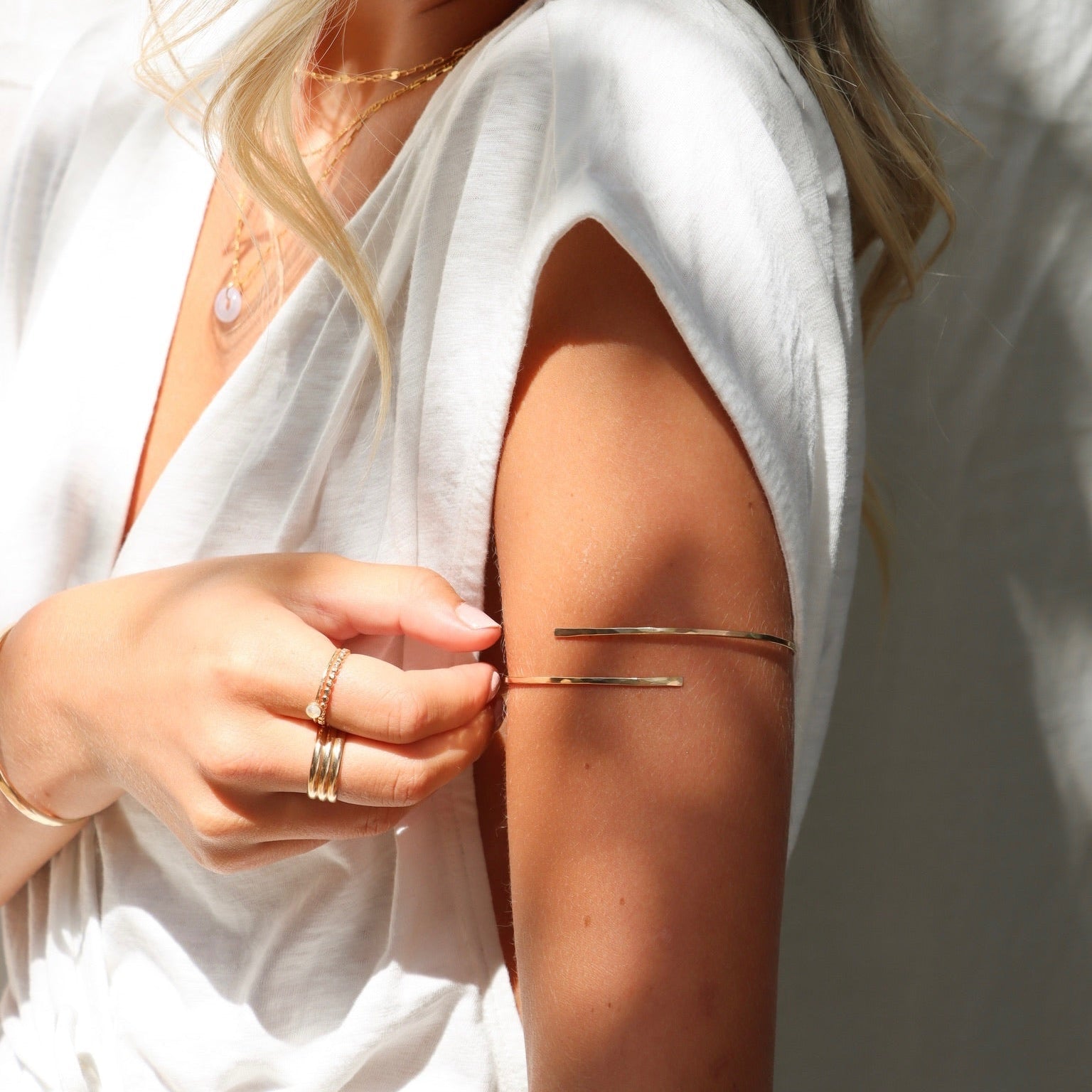 model wearing 14k gold fill arm cuff with other 14k gold fill jewelry