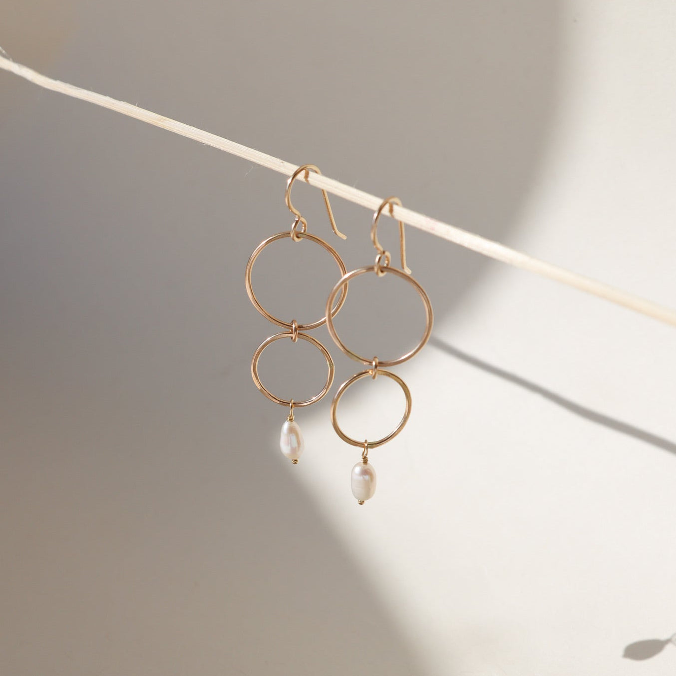 Ava Pearl Drop Earrings with minimalist gold ear wires and dangling freshwater pearls.
