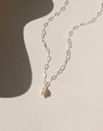 Ava Pearl Necklace with a minimalist gold chain and elegant freshwater pearl centerpiece.