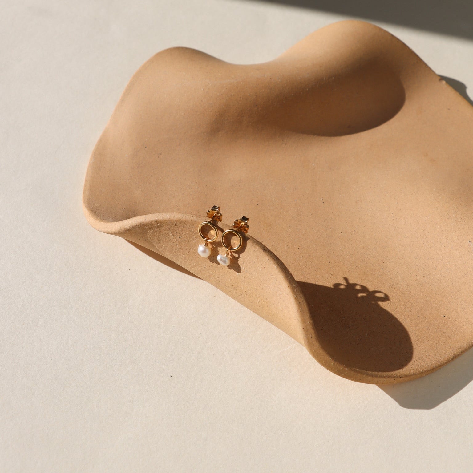 Ava Pearl Stud Earrings with minimalist gold settings and elegant freshwater pearls.