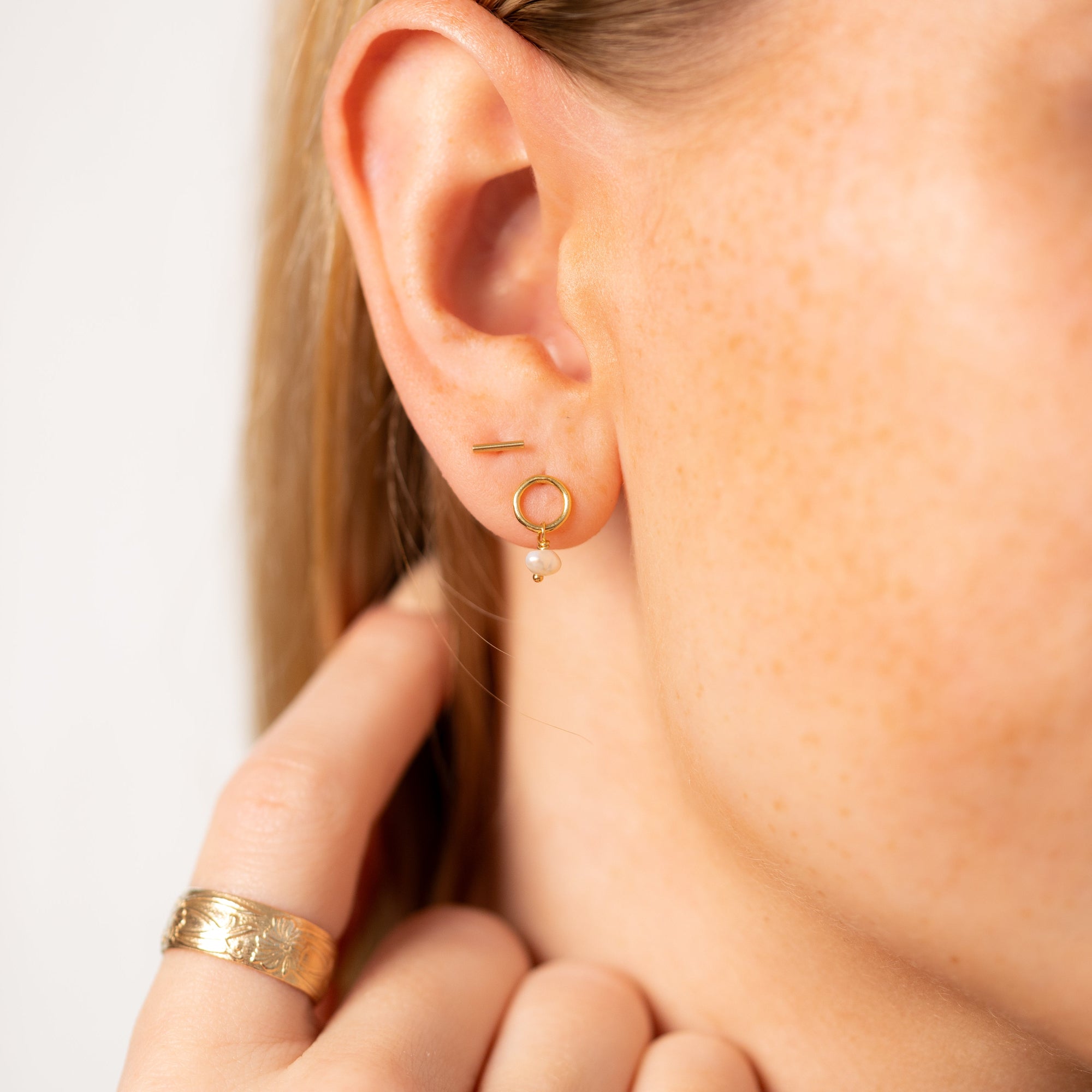 Ava Pearl Stud Earrings with minimalist gold settings and elegant freshwater pearls.
