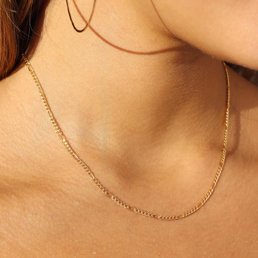 Model wearing 14k gold fill figaro chain necklace