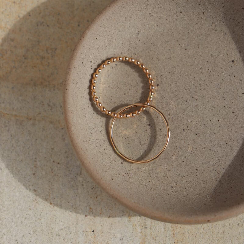 beaded wire ring and simple hammered stacking band entwined together. 14k gold fill or sterling silver. Handmade by Token Jewelry in Eau Claire, WI