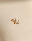 14k gold fill bezel ear posts with 4mm citrine stone on a light background