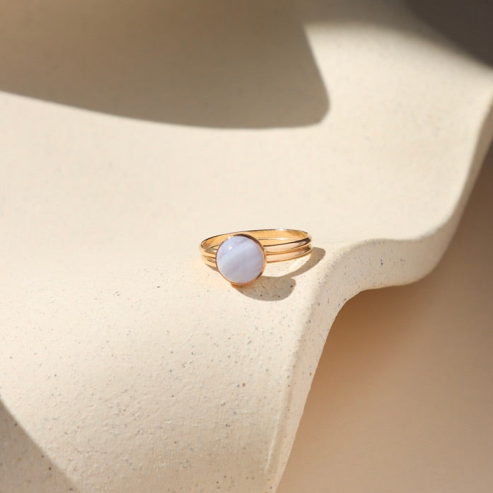 14k gold fill double band bezel ring with round blue lace agate stone on a light dish