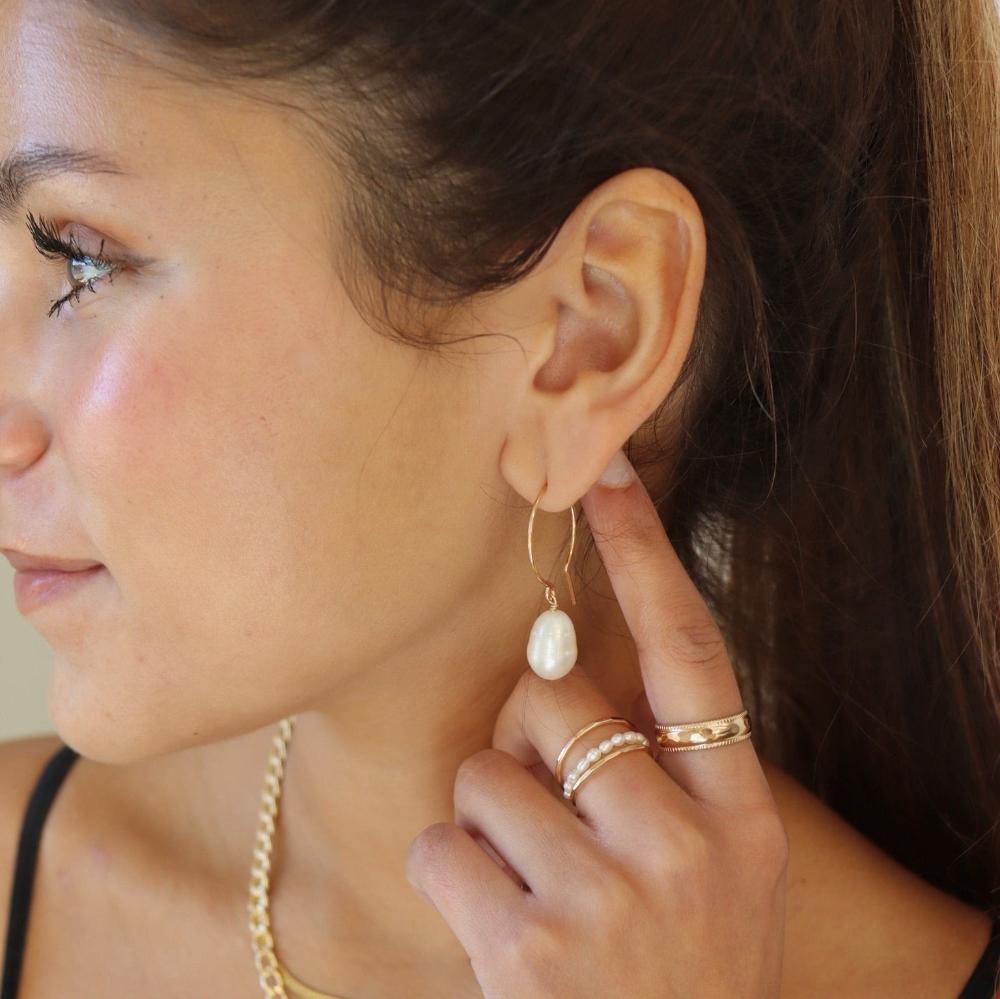 model wearing handmade 14k gold fill wire earrings with freshwater pearls