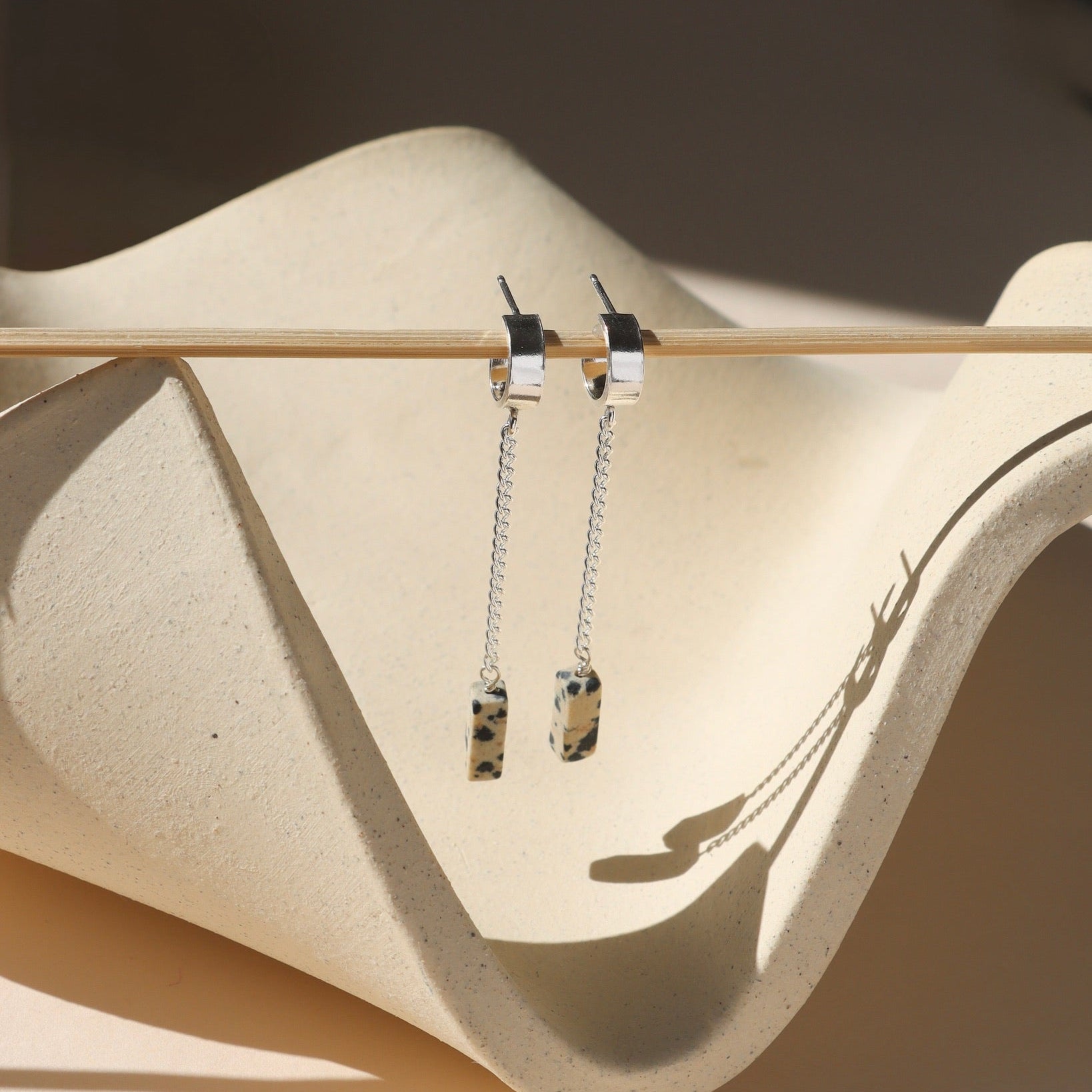 14k gold fill earrings with chain and dalmatian jasper beads in the sunlight