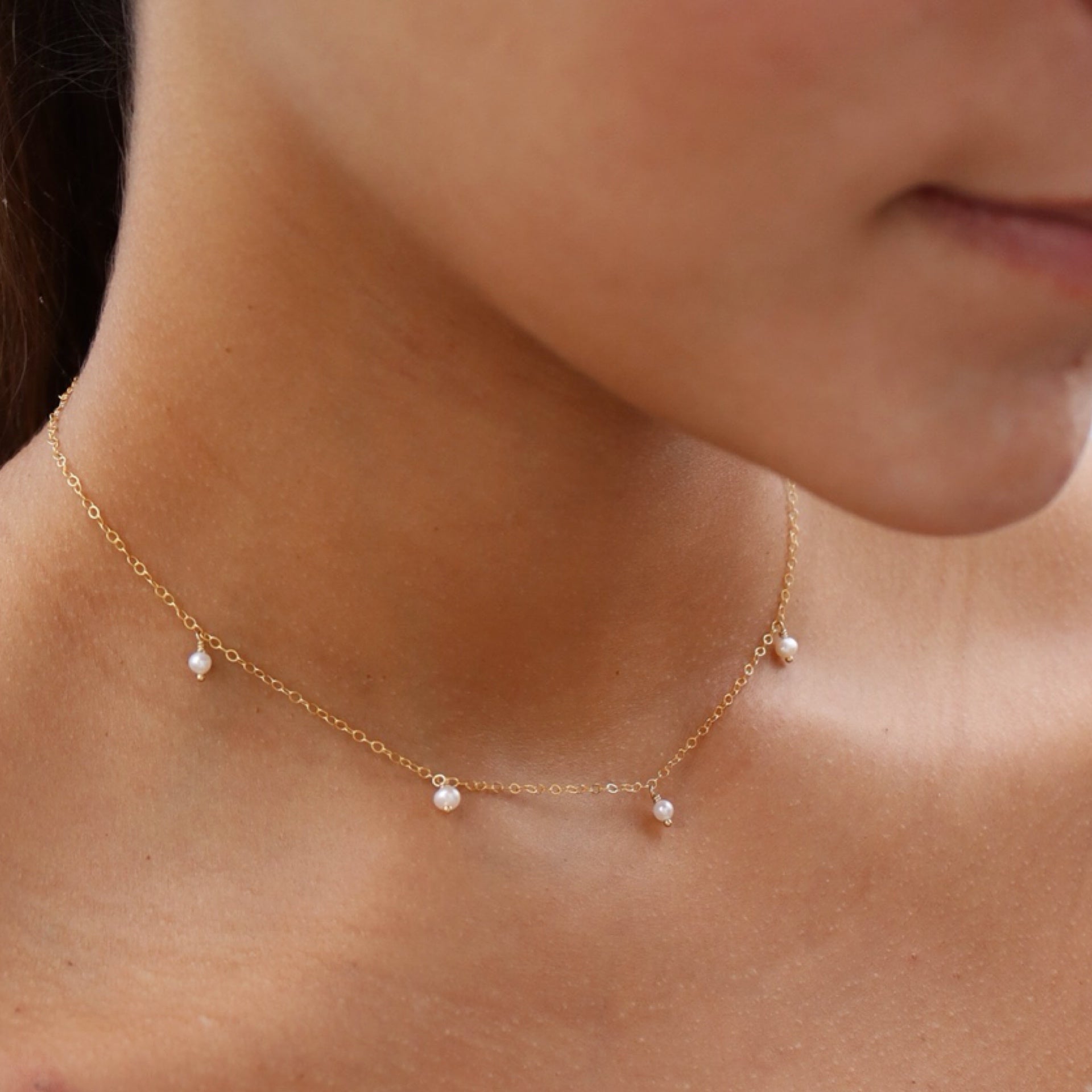 model wearing 14k gold fill dainty chain necklace with pearls 